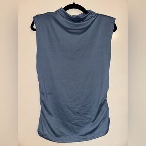 Soft women’s blouse with mock neck, shoulder pads, rouched sides